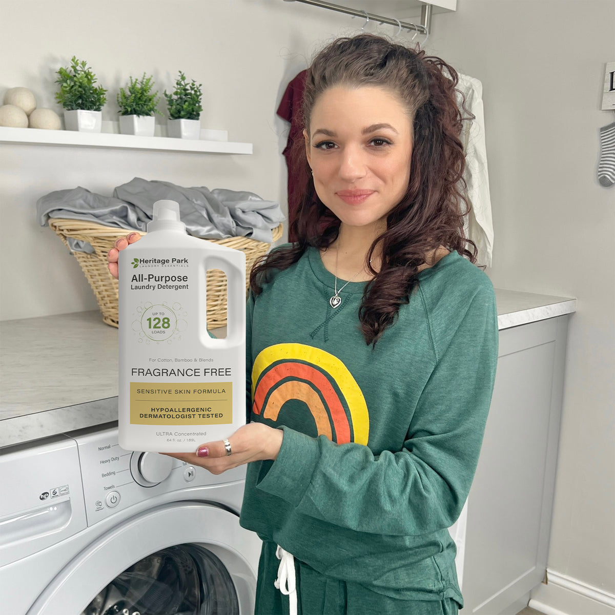 Woman in laundry room holding a bottle of laundry detergent