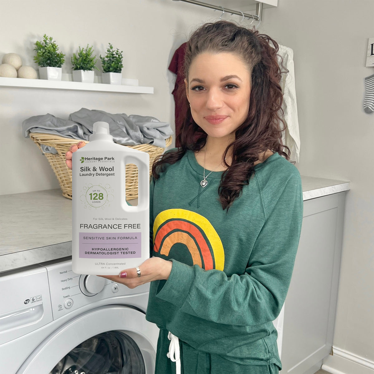 Woman in laundry room holding a bottle of laundry detergent