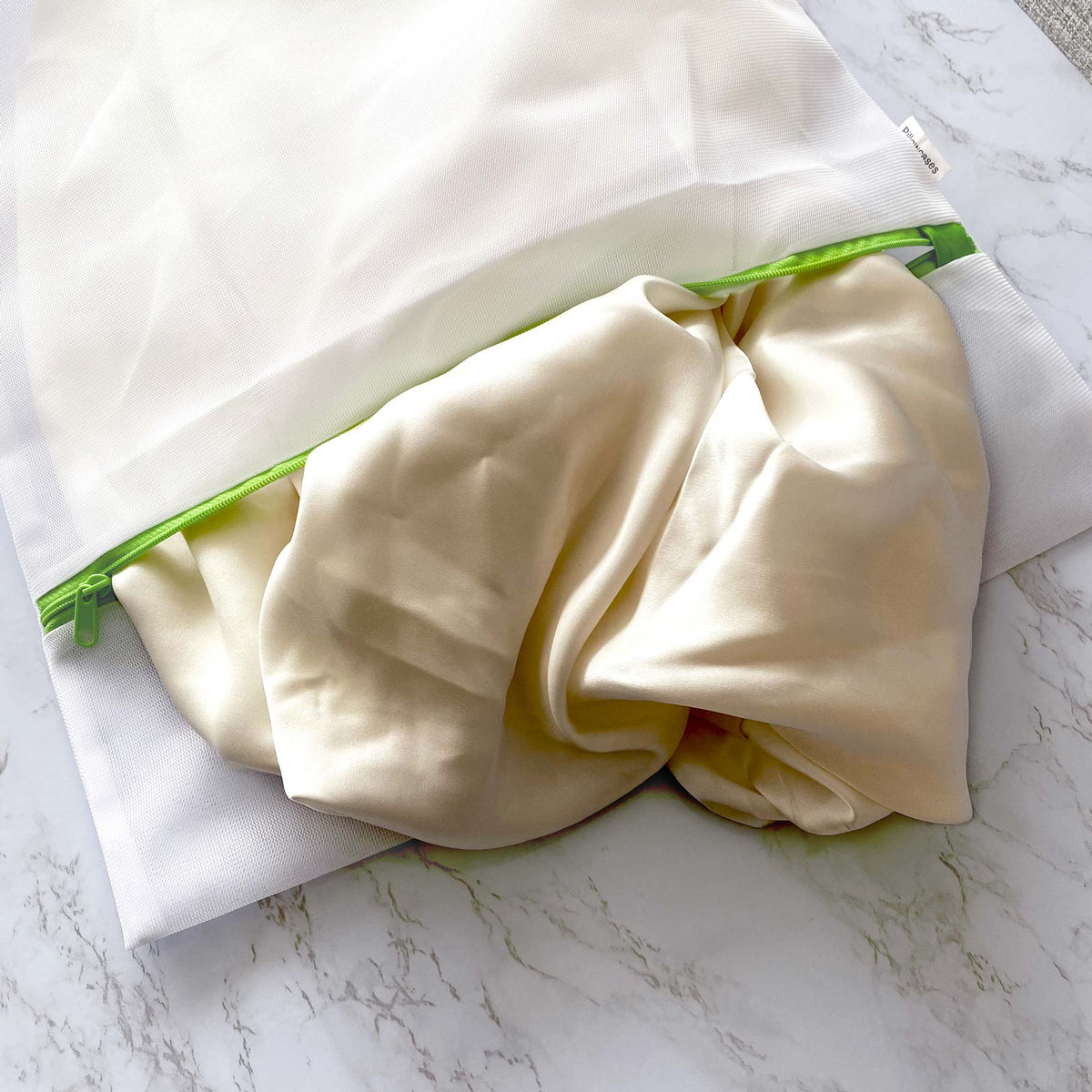 Heritage Park large mesh laundry bag holding a silk flitted sheet
