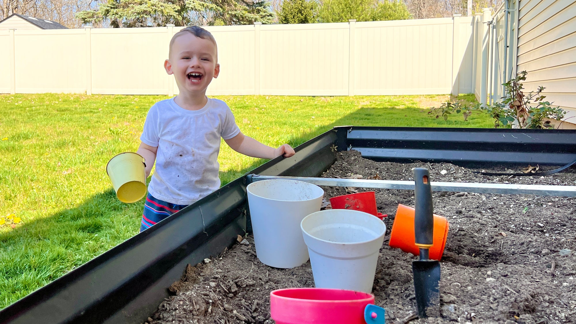 Toddler playing in a garden getting dirty