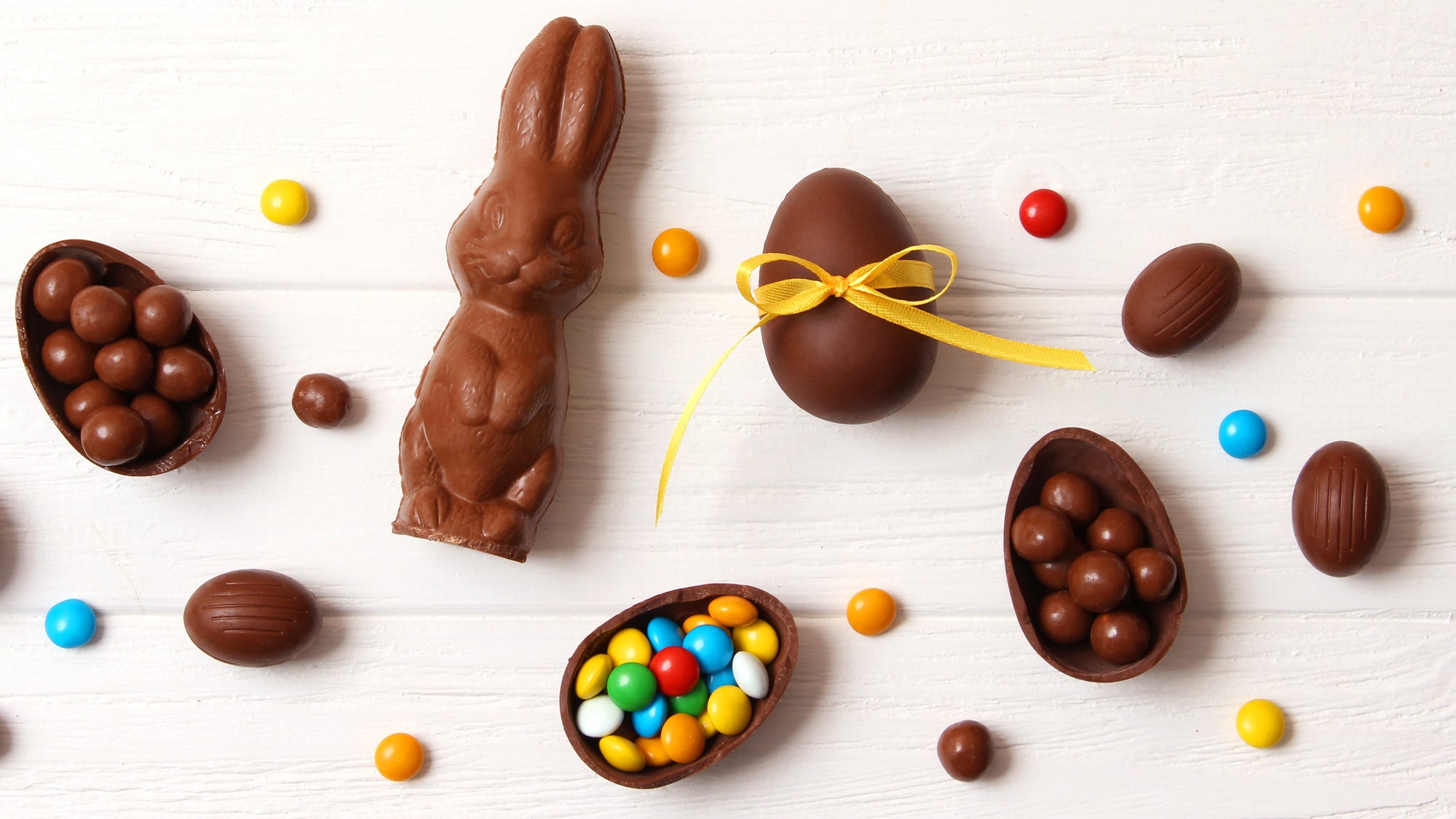 Chocolate Easter Bunny, eggs and candies spread out on a table
