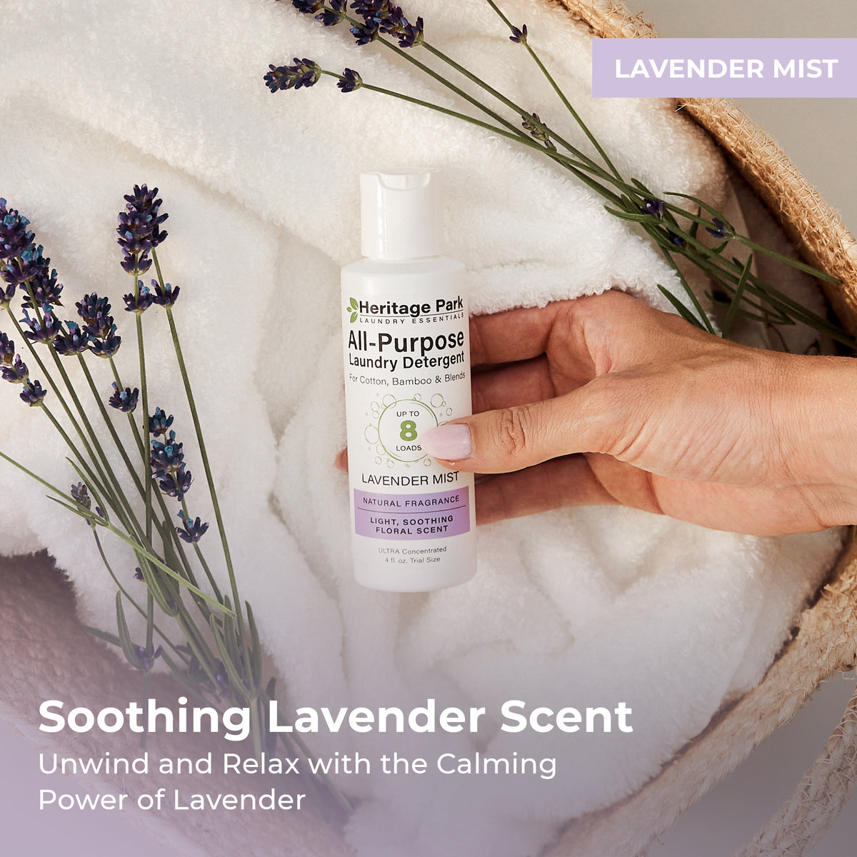 4oz bottle of Heritage Park All Purpose Laundry Detergent with lavender mist Fragrance on a laundry basket