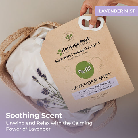 Lavender Mist Heritage Park Silk and Wool Laundry Detergent refill pack on a laundry basket