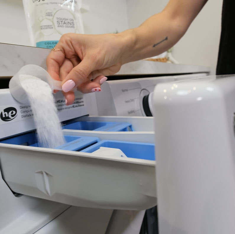 Pouring Naturally Bright Oxygen Powder into washing machine